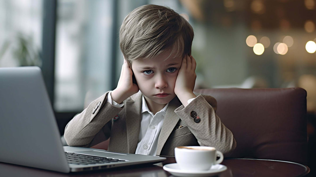 Well dressed boy looks sad with hands over ears