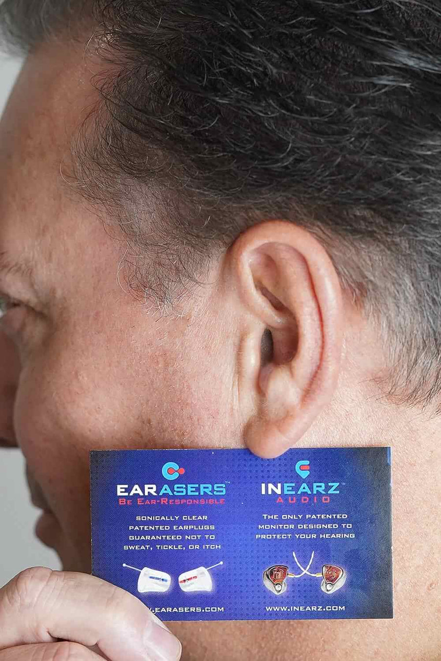 Example photo: an ear photographed from the side, with a business card held flat next to it