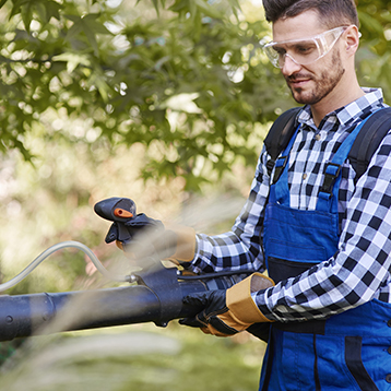 Guy in suspenders using blower