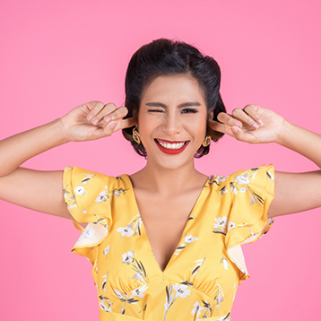 Girl with fingers in ears sensitive hearing