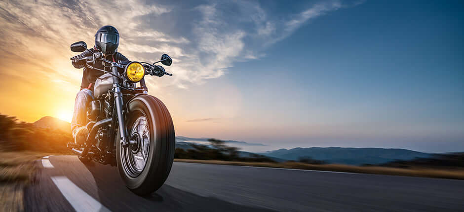 Man on motorcycle cruising down road